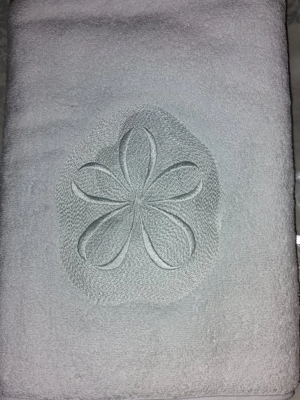 ANALI EMBROIDERED SAND DOLLAR HAND TOWEL 17 1/2